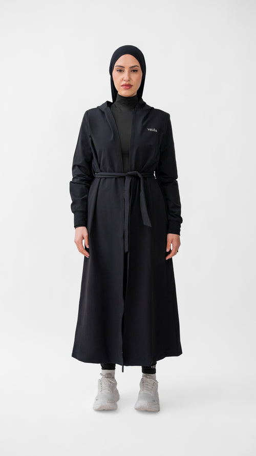 VELÉA Céleste Cloak — oversized hooded modest activewear layer in matte black